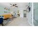 Bright living room with yellow couch, tiled floors, and beach decor at 724 Gulf Blvd # A & B, Indian Rocks Beach, FL 33785