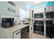 Modern kitchen featuring stainless steel appliances and white cabinetry at 724 Gulf Blvd # A & B, Indian Rocks Beach, FL 33785