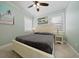 Bright bedroom with a comfortable bed and ceiling fan at 724 Gulf Blvd # A & B, Indian Rocks Beach, FL 33785