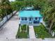 Quaint beach cottage with teal roof and landscaped yard at 724 Gulf Blvd # A & B, Indian Rocks Beach, FL 33785