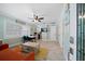 Bright living room with orange couch and dining area at 724 Gulf Blvd # A & B, Indian Rocks Beach, FL 33785