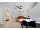 Open living area featuring a comfortable orange couch and dining table at 724 Gulf Blvd # A & B, Indian Rocks Beach, FL 33785
