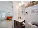Clean bathroom with single sink vanity and view into living room at 724 Gulf Blvd # A & B, Indian Rocks Beach, FL 33785