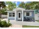Charming beach cottage with teal roof and landscaping at 724 Gulf Blvd # A & B, Indian Rocks Beach, FL 33785