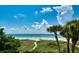 Scenic beachfront property with palm trees and a path leading to the beach at 724 Gulf Blvd # A & B, Indian Rocks Beach, FL 33785