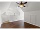 Spacious loft bedroom with hardwood floors and ceiling fan at 9282 Lake Chase Island Way # 9282, Tampa, FL 33626