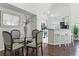 Bright dining area with glass table and four chairs, adjacent to kitchen at 9282 Lake Chase Island Way # 9282, Tampa, FL 33626