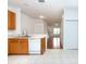 Kitchen with a view into the living area, wood cabinets, and tile floor at 12707 Sunland Ct, Tampa, FL 33625