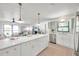 Modern kitchen with white and green cabinets and a large island at 1164 Murok S Way, St Petersburg, FL 33705