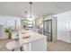 Modern kitchen with white and green cabinets and a large island at 1164 Murok S Way, St Petersburg, FL 33705