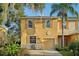 Tan two-story townhome with garage at 13960 Snapper Fin Ln, Tampa, FL 33637