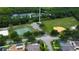 Aerial view shows community park with baseball diamond, basketball, volleyball, and tennis courts at 11426 Glenmont Dr, Tampa, FL 33635