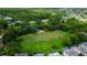 Aerial view of a neighborhood park featuring a playground and green space, nestled amongst houses and lush trees at 11426 Glenmont Dr, Tampa, FL 33635