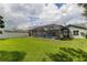 Large backyard features screened-in pool, well-kept lawn, and mature trees and landscaping at 11426 Glenmont Dr, Tampa, FL 33635