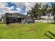Well-maintained backyard features a screened pool area, lawn, and mature trees at 11426 Glenmont Dr, Tampa, FL 33635
