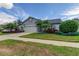 Inviting home featuring mature landscaping, a two-car garage, and a welcoming entrance at 11426 Glenmont Dr, Tampa, FL 33635
