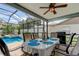 Covered outdoor dining area and BBQ near a sparkling pool, perfect for entertaining and outdoor cooking at 11426 Glenmont Dr, Tampa, FL 33635
