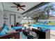 Comfortable screened patio with wicker furniture overlooks a sparkling pool, perfect for relaxation and entertaining at 11426 Glenmont Dr, Tampa, FL 33635