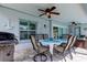 Covered outdoor dining area with ceiling fan, table, and grill for entertaining near the refreshing outdoor space at 11426 Glenmont Dr, Tampa, FL 33635