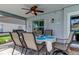 Covered outdoor dining area with ceiling fan, table, and grill for entertaining near the refreshing outdoor space at 11426 Glenmont Dr, Tampa, FL 33635