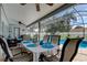 Screened patio featuring a dining area and seating area, adjacent to a sparkling pool for outdoor enjoyment at 11426 Glenmont Dr, Tampa, FL 33635