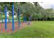 Outdoor fitness and play area with exercise equipment surrounded by lush greenery at 11426 Glenmont Dr, Tampa, FL 33635