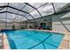 Inviting in-ground pool inside screened enclosure with covered patio and outdoor seating at 11426 Glenmont Dr, Tampa, FL 33635