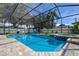 Sparkling pool and spa with a screen enclosure, patio, and comfortable seating, perfect for relaxation and enjoyment at 11426 Glenmont Dr, Tampa, FL 33635
