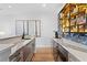 Modern wet bar area featuring marble countertops, custom shelving with lighting and hardwood floors at 4536 W Swann Ave, Tampa, FL 33629