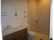 Well-lit bathroom features a wood vanity with sink and a tiled walk-in shower at 4536 W Swann Ave, Tampa, FL 33629