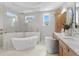 Elegant bathroom featuring a soaking tub, glass shower, double sinks, and designer fixtures at 4536 W Swann Ave, Tampa, FL 33629