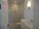 Bathroom with a modern vanity, neutral color scheme, walk-in shower, and stylish light fixture at 4536 W Swann Ave, Tampa, FL 33629