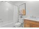 Bright bathroom featuring a tub with a shower, white tile, and decorative accents at 4536 W Swann Ave, Tampa, FL 33629