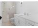 Contemporary bathroom with white cabinets, quartz countertop, and a glass enclosed shower with tile surround at 4536 W Swann Ave, Tampa, FL 33629