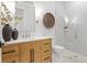 Elegant bathroom with a wood vanity, sleek fixtures, glass shower, and modern design for a luxurious feel at 4536 W Swann Ave, Tampa, FL 33629