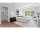 Bright bedroom with hardwood floors, comfortable seating, and large windows for natural light and a relaxed feel at 4536 W Swann Ave, Tampa, FL 33629