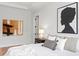 Bright bedroom featuring modern art, tray ceilings, and warm wood floors, creating a luxurious retreat at 4536 W Swann Ave, Tampa, FL 33629