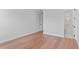 Minimalist bedroom featuring hardwood floors and an adjacent bathroom with a glass enclosed shower at 4536 W Swann Ave, Tampa, FL 33629