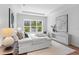 Sunlit bedroom featuring a large window, modern décor, and hardwood floors, creating a serene atmosphere at 4536 W Swann Ave, Tampa, FL 33629