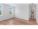 An empty bedroom boasts hardwood floors, white walls, and natural light from two windows at 4536 W Swann Ave, Tampa, FL 33629