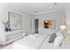 Airy bedroom with tray ceilings, wood floors, and modern art creates a bright and relaxing space at 4536 W Swann Ave, Tampa, FL 33629