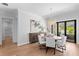 Bright dining room with wood floors, modern chandelier, and sliding glass doors to the outdoor area at 4536 W Swann Ave, Tampa, FL 33629