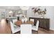 Open concept kitchen and dining area featuring a round wooden table with white chairs and beaded chandelier at 4536 W Swann Ave, Tampa, FL 33629