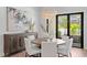 Well-appointed dining room with modern light fixture, elegant furniture, and outdoor view at 4536 W Swann Ave, Tampa, FL 33629