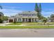 Beautiful two-story home featuring white brick, a covered porch with columns, and lush landscaping at 4536 W Swann Ave, Tampa, FL 33629