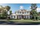 Two story home with a front porch, attached garage, and mature landscaping at 4536 W Swann Ave, Tampa, FL 33629