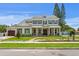 Beautiful two-story home featuring white brick, a covered porch with columns, and lush landscaping at 4536 W Swann Ave, Tampa, FL 33629
