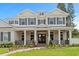 Elegant home showcasing white columns, a covered porch, and manicured landscaping under a blue sky at 4536 W Swann Ave, Tampa, FL 33629