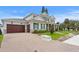 View of a two-story home with a side-entry three-car garage and brick paver driveway at 4536 W Swann Ave, Tampa, FL 33629