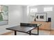 Game room features a ping pong table, stylish decor and hardwood flooring at 4536 W Swann Ave, Tampa, FL 33629